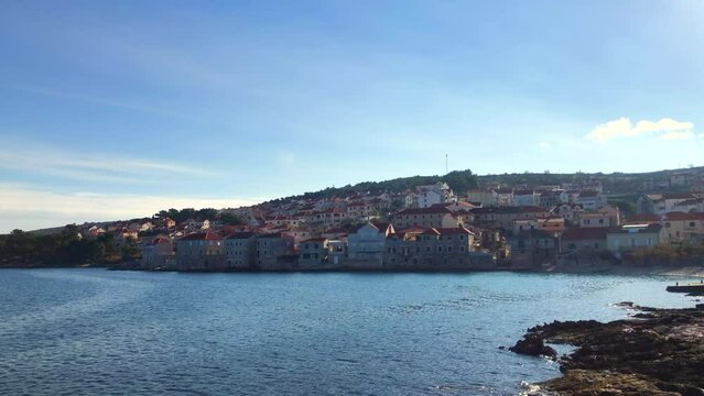 Slow motion view of beautiful European seaside town. Coastal town of Postira. Brac Island, Croatia. Europe.