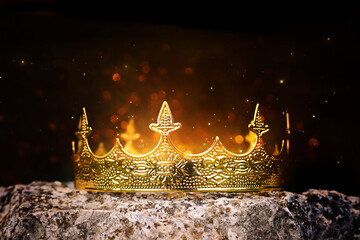 low key image of beautiful queen or king crown over stone. vintage filtered. fantasy medieval period