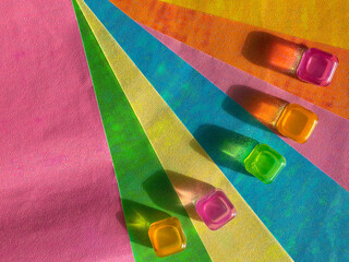 Colorful fan-shaped backgrounds and transparent bright cubes lie