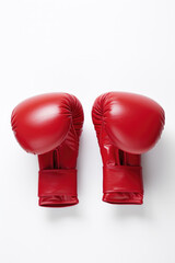 Fototapeta na wymiar Red boxing gloves laying on white background