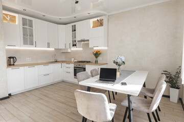 a modern white kitchen interior with wooden worktop