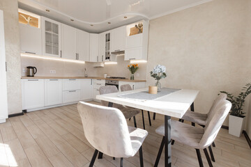 Fototapeta na wymiar a modern white kitchen interior with wooden worktop