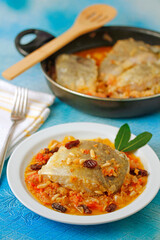 Cod with raisins and pine nuts.
