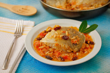 Cod with raisins and pine nuts.