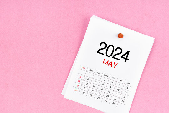 ?ฟั 2024 calendar page and wooden push pin on pink background.