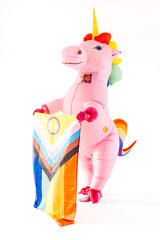 Pink inflatable unicorn holding rainbow flag