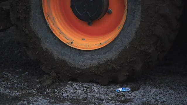 Close view big truck wheel.  Large wheel on dirty. Construction works.