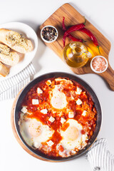 Shakshuka made of poached eggs in tomato pepper sauce