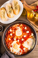 Shakshuka made of poached eggs in tomato pepper sauce