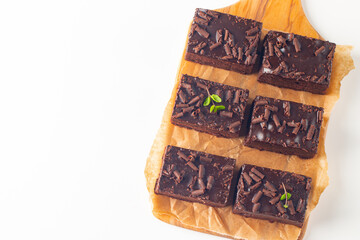 Delicious chocolate brownies with mint on white background. Sweet cake concept. 