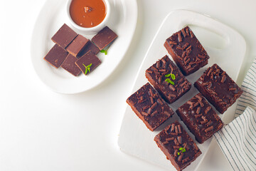 Delicious chocolate brownies with mint on white background. Sweet cake concept. 