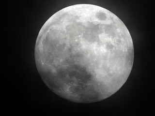 full moon behind the misty clouds 