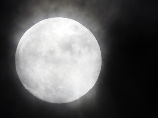 full moon behind the misty clouds 