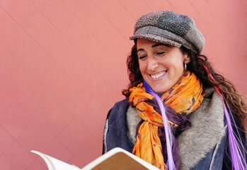 a stylish mature woman reading a book outside. world book day. sant jordi