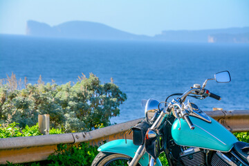 Classic motorcycle parked by the sea
