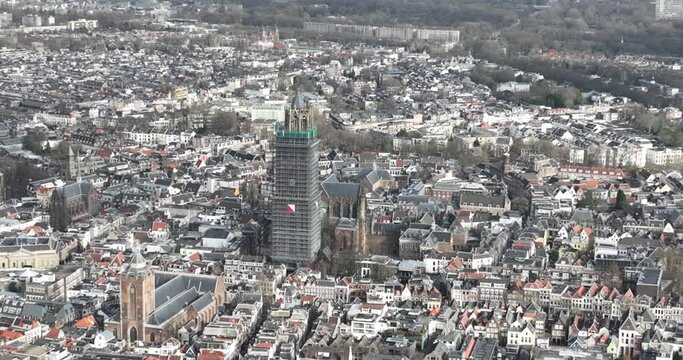 Aerial drone view on the Utrecht Cathedral in scaffolding for renovation. Gothic church in the middle of the Dutch city of Utrecht . Monument and city centre landmark.