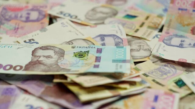 Banknotes, an indicator of economic activity, are spread out on the table. This indicates strong entrepreneurial activity and influence on the market. High quality 4k footage
