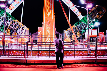 man at a carnival by night