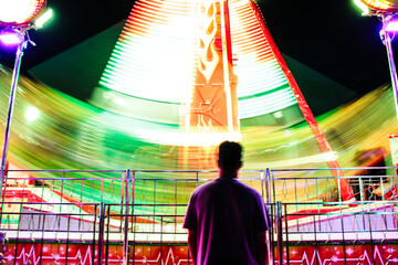 man at a carnival by night