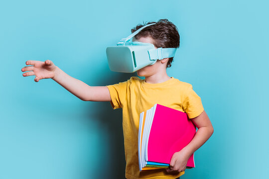 A schoolboy clad in a yellow t-shirt and VR glasses reaches out, merging traditional education with futuristic technology