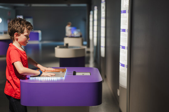 Young boy engaging in interactive exhibit at science museum