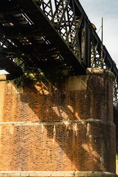  A large brick and stone masonry arch bridge over the Kuala Kangsar river in Malaysia.