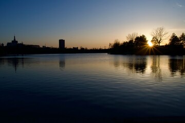 Naklejka premium sunset over the river, Baneasa Lake, Bucharest City, Romania