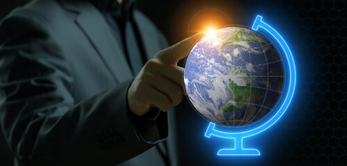 Businessman pointing his finger to planet earth model on blue neon stand. Concept for environment,...
