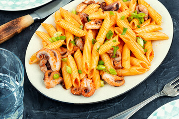 Pasta, macaroni with octopus pieces.