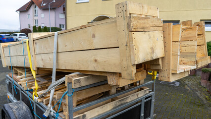 Trailer with lumber wooden boards for the house
