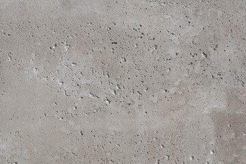gray smooth concrete surface with small depressions and streaks
