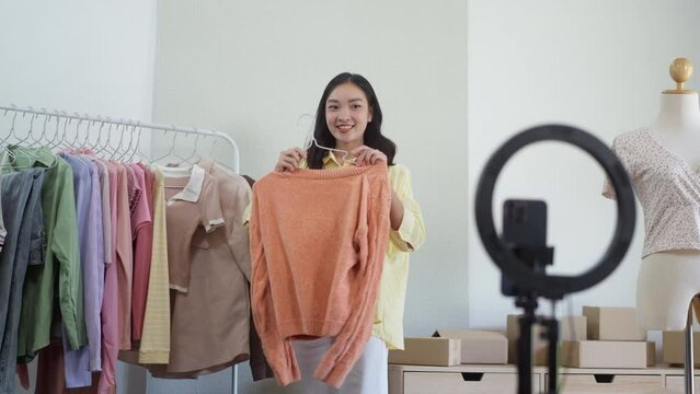 Female asian live streaming online for sale a clothes, e-commerce and marketing Social media