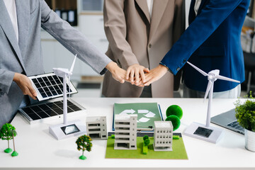 Business team people planning and discussing on recycle reduce reuse policy symbol in office meeting room. Green business company and Solar Energy Environment city