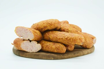 Meat dish sausage on a wooden board. The product is ready to use. White background.
