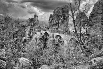The Bastei Bridge in Saxon Switzerland in black and white. jagged rocks. Tourist