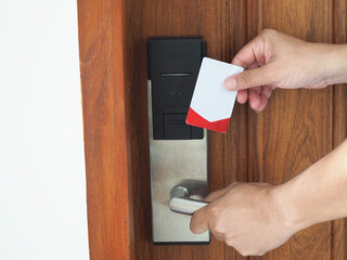 Digital door. Door access control - man hand holding white mockup key card to lock and unlock door.