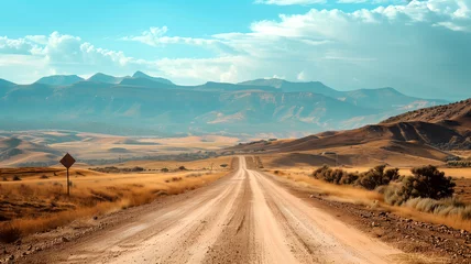Foto auf Glas Dirt road leading through a dry landscape to mountains representing travel, adventure, journey, and exploration. © mr_marcom