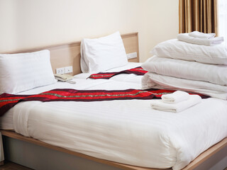 Side view of hotel amenities (such as towels, hankie, etc) on the bed. 