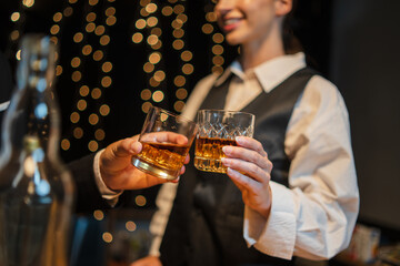 Barwoman pouring whiskey whiskey glass..