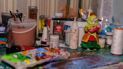 The Artist's Colorful Workspace: A Table Laden with Paints, Creating a Working Atmosphere
