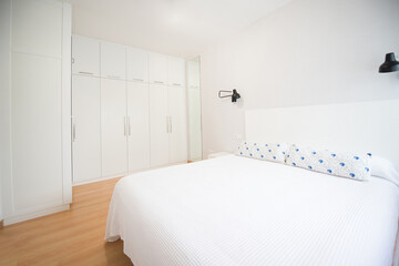 Fototapeta na wymiar modern bedroom of a home with its bed and wardrobe