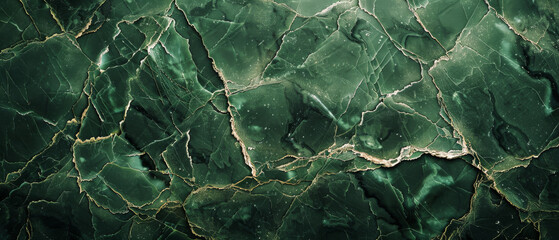 Close-up view of a green stone with deep cracked patterns, resembling an aerial view of an earthy landscape