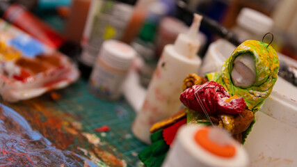The Artist's Colorful Workspace: A Table Laden with Paints, Creating a Working Atmosphere