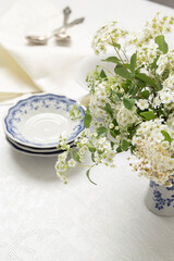 Spring breakfast. Freshness and calm of first spring days. Flowers and served table for tea, coffee time