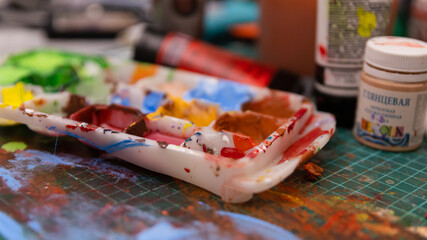 The Artist's Colorful Workspace: A Table Laden with Paints, Creating a Working Atmosphere