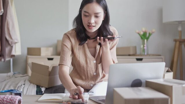 Small business owner preparing parcel for delivery online selling sell Online on the Internet from home.
