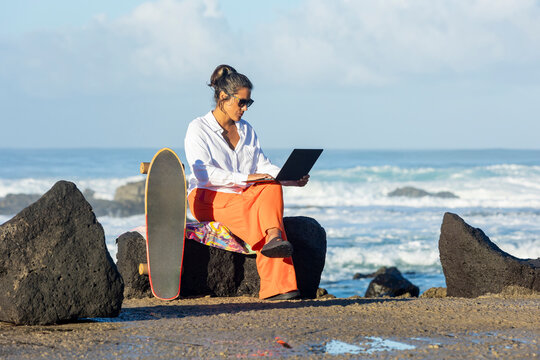 Digital female nomad working by the ocean in Fuerteventura