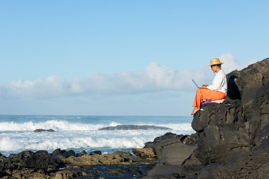 Digital nomad working by the ocean in Fuerteventura