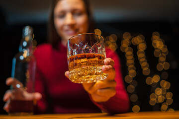 Barwoman pouring whiskey whiskey glass..