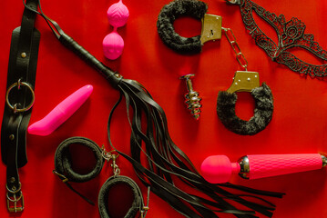 Set of toys for adults: handcuffs, anal plug, mask, whip, vibrator. The view from the top - obrazy, fototapety, plakaty